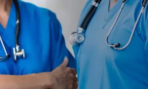 BSN Prepared Nurses in Blue Scrubs Discussing Patient Care